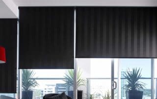 Apartment Living room with black roller blinds for sliding door and windows facing a balcony Apartment Living room with black roller blinds for sliding door and windows facing a balcony